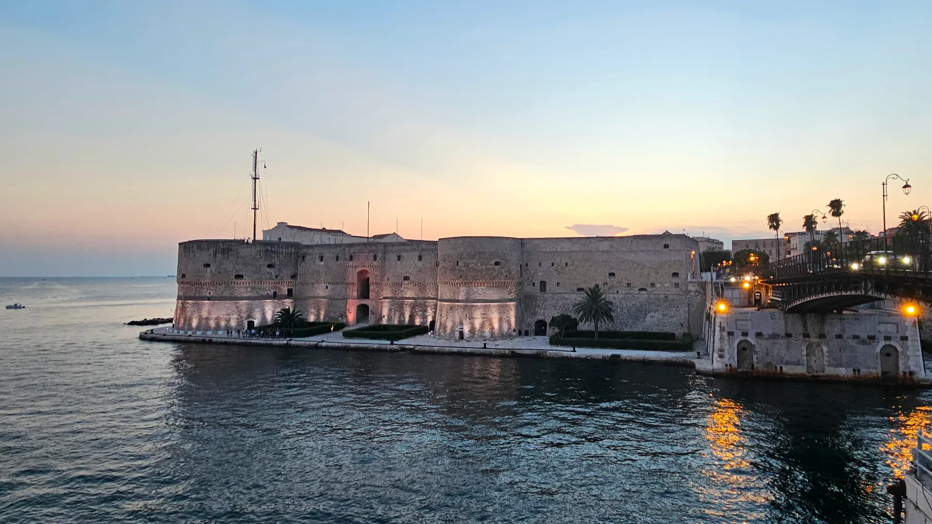 Aragonese Castle of Taranto at sunset with sea view and swing bridge